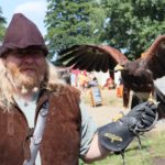 A handler and his hawk at a medieval festival